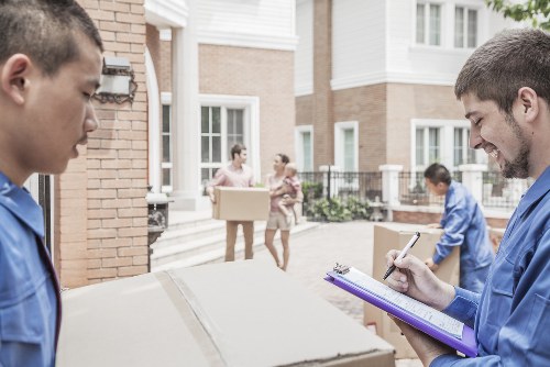 Removal team handling a Chelsea home move on a narrow London street