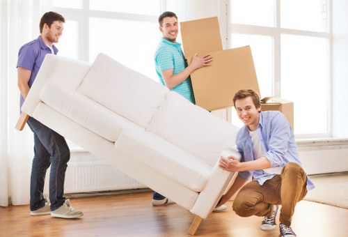 Removal team collecting a sofa and table from a Chelsea apartment building