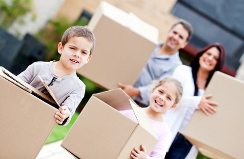 Packed moving boxes and furniture ready for collection in Chelsea