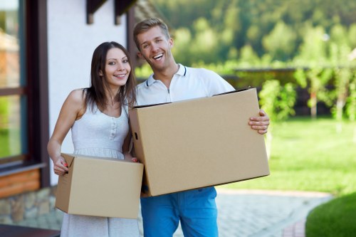 Professional moving team with packing materials and furniture protection