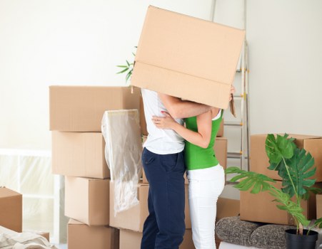 Moving team carrying furniture through a Chelsea property