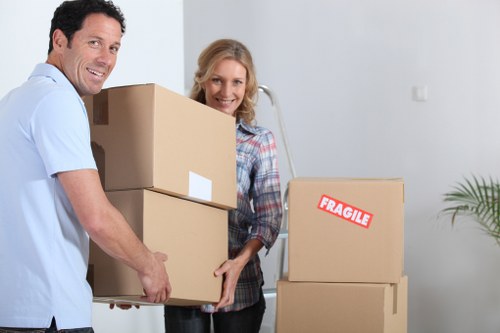 Professional movers loading items from a flat with careful access planning